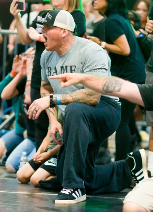 Coach supporting a wrestler during competition