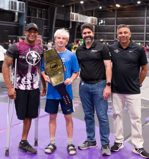 Anthony Robles and Joe Valle posing with a winning wrestler