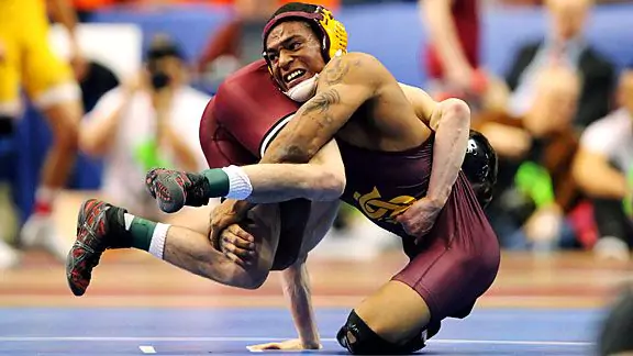 Arizona State wrestler Anthony Robles performing a wrestling move during a match.